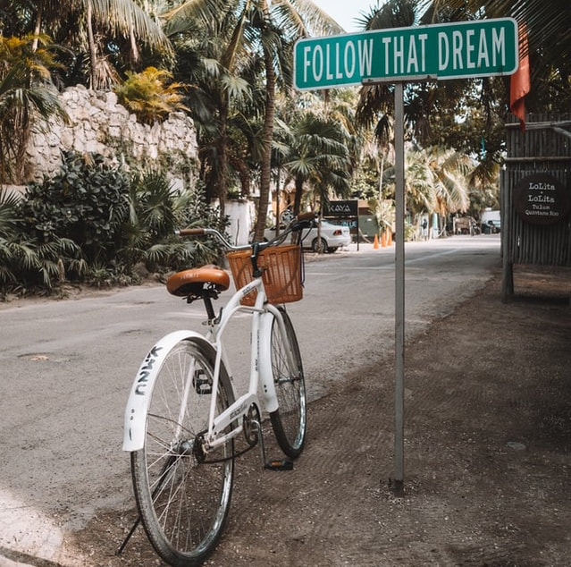 Follow that dream sign bike on street | Creativity Counseling and Creativity Coaching Online in Maryland and Virginia at Creatively, LLC, Counseling for Artists