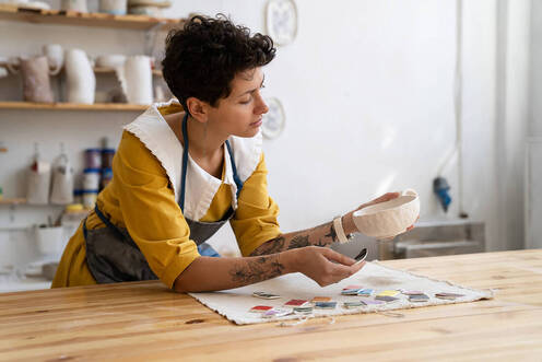 Picture of a working artist sculpting a bowl and looking thoughtful. Creativity counseling and coaching for creative people in Maryland and Virginia can be explored here! Creative people can find meaning and purpose here.