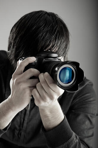 Picture of a photographer holding a camera up to his eye. When dealing with anxiety and creativity in Richmond, VA, Seasonal Affective Disorder (SAD) can be helped with concierge counseling services in Baltimore, MD for creative people in the United States. See how mental health and creativity can support your overall wellness. 