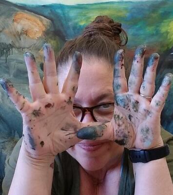 Photos of Racquel Keller, Artist, photo of artist face with hands in front, paint on fingers, smiling |  Interview with an Artist at Creatively, LLC, Cindy Cisneros, Creativity Coach, interviews local artist, Racquel Keller
