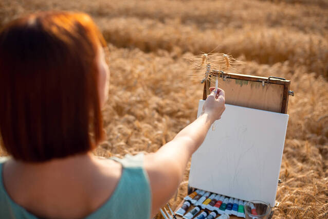 Picture of an artist in the wheat doing art. Talk with a creativity coach in the United States, Germany, Canada, UK and beyond. Get started with creativity coaching in Richmond, VA and Baltimore, MD and the Washington D.C. area here!