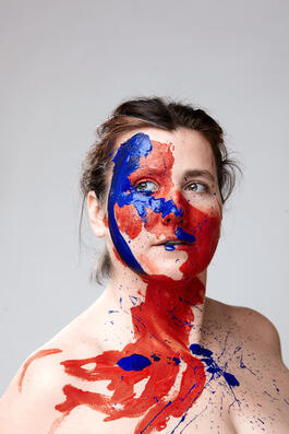 Picture of a person looking off screen with paint on their face. Creative people in Maryland and Creative people in Virginia have support for their mental health with creativity counseling and coaching in Baltimore, MD, Richmond, VA and beyond. Reach out!