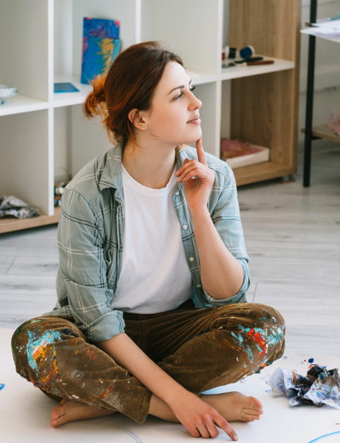 Concierge Counseling in Maryland, Therapy for Artists, Therapy for Artists in Maryland and Virginia |  Young Adult Caucasian female sitting on floor, thoughtful, in profile, in art studio