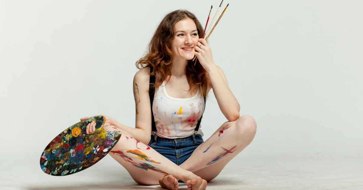 Therapy for Artists in Maryland and Virginia, Therapy for Creatives in Maryland |  Young Caucasian Adult Female holding paint palette and brushes with white background